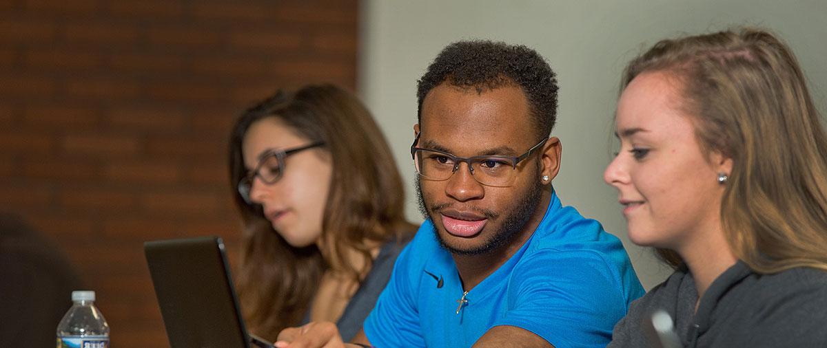 University of Mount Union students in classroom looking at a computer 